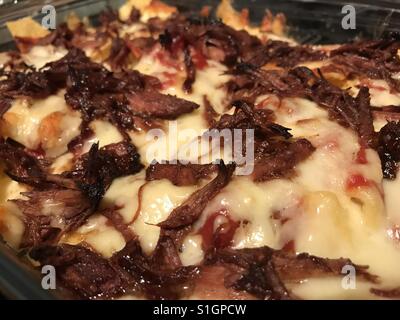 Pulled pork and cheese nachos fresh out of the oven Stock Photo