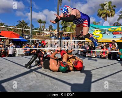 Lucha Libre Mexican Wrestling match with wrestler performing a body drop. Lucha Libre is Spanish for free fight and is a term used in Mexico for a form of professional wrestling. Taken 6 May 2016. Stock Photo