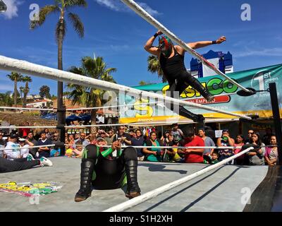 Lucha Libre Mexican Wrestling match with wrestler performing a body drop. Lucha Libre is Spanish for free fight and is a term used in Mexico for a form of professional wrestling. Taken 6 May 2016 Stock Photo