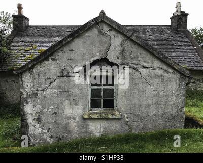 Cracks in the brickwork around the window of an remote old house on the Isle of Mull, Scotland. Stock Photo