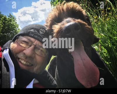 Man taking a selfie with his pet dog Stock Photo