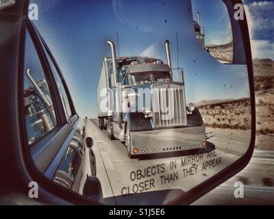 View of truck in SUV side mirror, between Las Vegas and Los Angeles Stock Photo