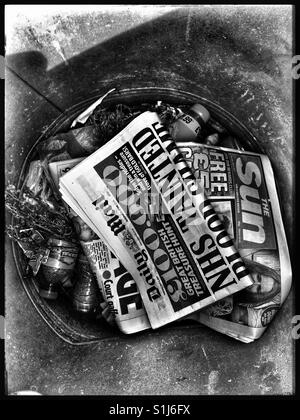 Tabloids discarded in a rubbish bin. Stock Photo