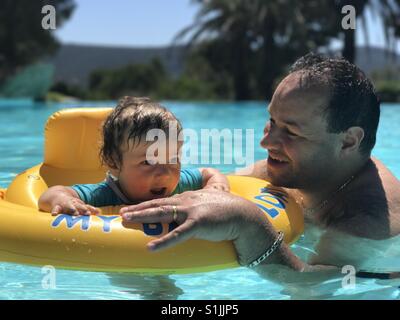 Father and baby son in swimming pool Stock Photo