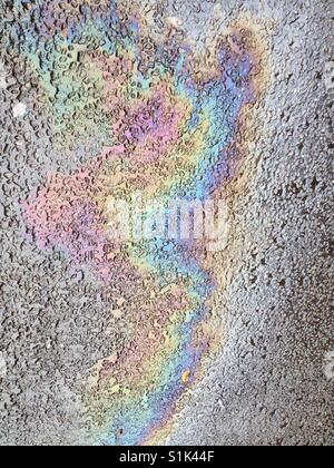 Oil slick close up on a road in Cheshire, England (portrait orientation). Taken by Matthew Oakes. Stock Photo
