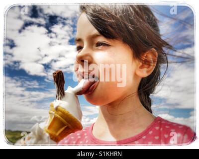 Girl eating a 99 ice cream Stock Photo