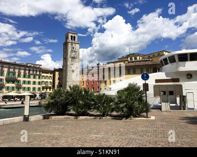Riva del Garda, Lake Garda, Italy-May 2017: a ferry is moored on the quayside in the small harbour in front of the town square Stock Photo