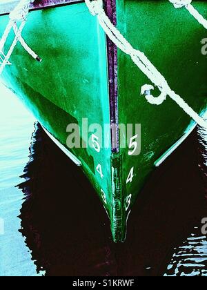 Ship's draft on green hull of moored ship. The vertical distance between the waterline and the bottom f the hull. Stock Photo