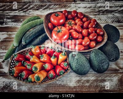 Fruit and vegetables: cucumbers, Armenian cucumbers, tomatoes, avocados, assorted small peppers Stock Photo