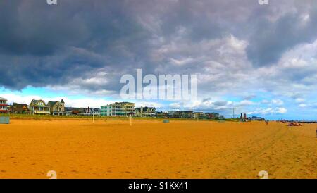 Dark clouds and blue clouds over Asbury park beach jersey shore Stock Photo