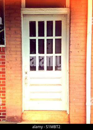 White door, peach brick Stock Photo