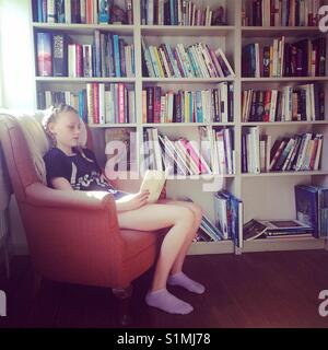 Teenager reading a book Stock Photo