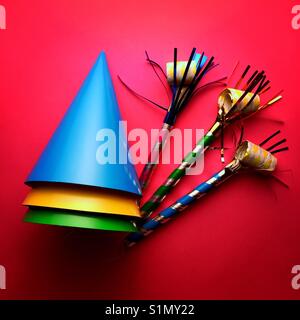 A bright colourful shot of party hats and noise makers Stock Photo