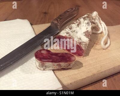 French saucisson sec - a dried pork sausage served as a beer snack in many bars. Stock Photo