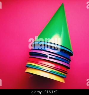 A bright colourful detail shot of a stack of party hats Stock Photo