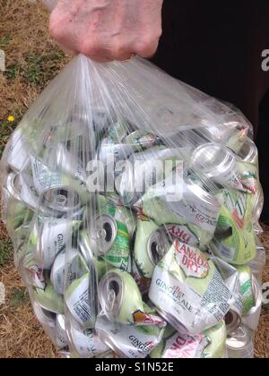 Man carrying a large bag of aluminum cans to be recycled Stock Photo