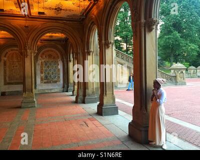 A young girl stood with emotion at the lower level of the Bethesda Terrace, Central Park, New York City, New York. Stock Photo
