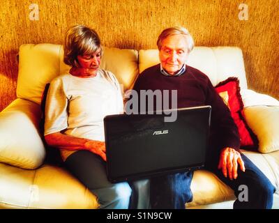 Old age pensioners using a laptop computer Stock Photo
