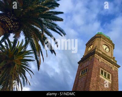 Old Art Deco clock tower in St. Kilda Melbourne with palm trees Stock Photo