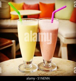 Two glasses of smoothie on a table in an empty cafe Stock Photo