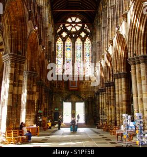 An interior shot of Glasgow Cathedral - dedicated in 1186 showing the West Nave and the stained glass window of “The Creation” by Francis Spear. Stock Photo