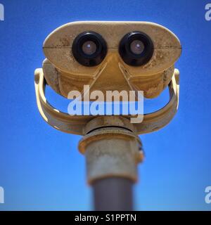 Sightseeing binoculars on blue sky background Stock Photo
