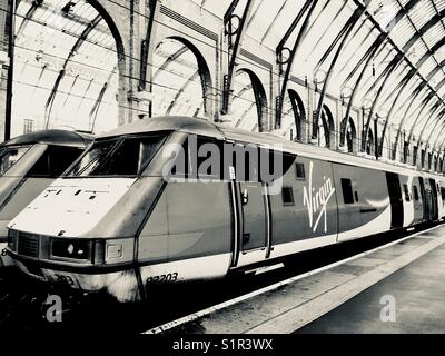 A Virgin train on the platform at Kings Cross station in London Stock Photo