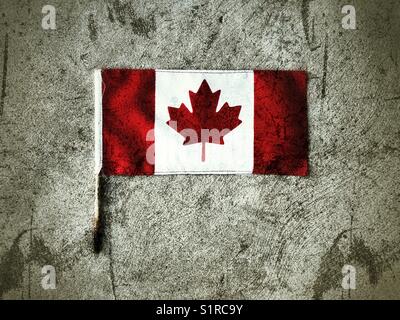 Small Canada flag laying on concrete Stock Photo