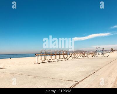 A blue bike parked in a bike rack at the beach. Manhattan Beach, California USA. Stock Photo