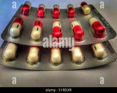 Red an white gel tablets in blister packs Stock Photo