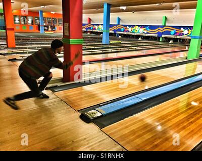 Young man bowling Stock Photo