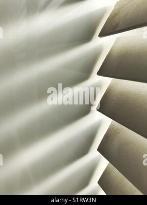 Light shining through bathroom blinds onto white tiles Stock Photo