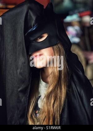 5 year old girl dressed up in Batman costume Stock Photo