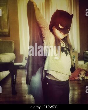 Five year old girl dressed up in Batman costume Stock Photo