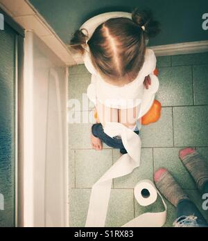 View from above of potty training toddler girl at home in bathroom Stock Photo