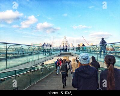 People walking over Millennium Bridge, designed by Norman Foster. St Paul's Cathedral is seen in the distance. Photo taken on November 3 2017 Stock Photo