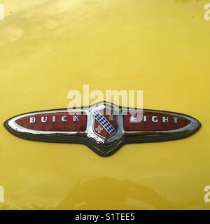 Buick eight sign on yellow 1950’s vintage car Stock Photo