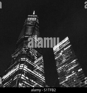 Looking up at One World Trade Center (left) at night, New York City Stock Photo
