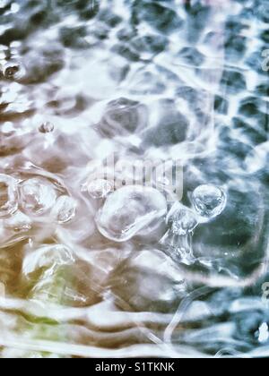 Boiling water seen through a glass and stainless steel kettle Stock Photo