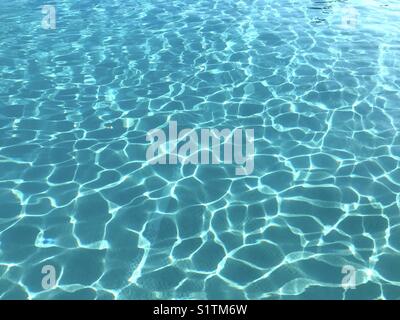 Pattern of sunlight on the water of a swimming pool Stock Photo