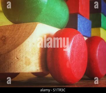 Closeup of child’s wooden toy block train with pieces painted in red, blue, green and yellow Stock Photo