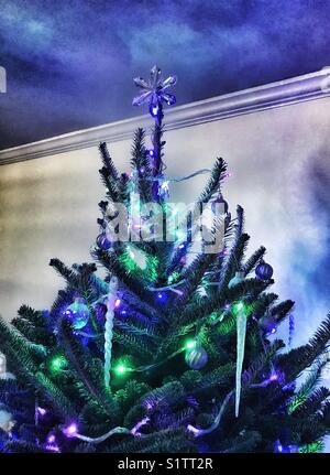 Decorated Christmas tree with crystal star on top Stock Photo