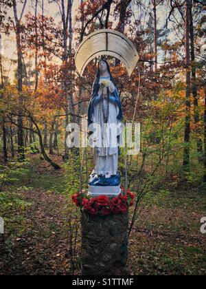 Small Virgin Mary statue in Kampinos Forest near Warsaw, Poland Stock Photo