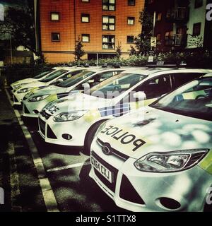 Police cars parked in marked bays, UK Stock Photo
