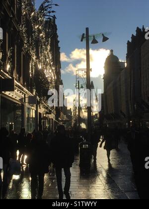 Christmas Shopping silhouettes in the main shopping area of Buchanan Street, Glasgow, Scotland Stock Photo