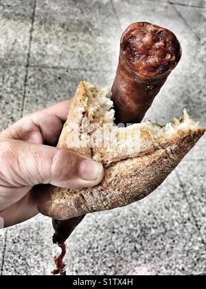Spanish snack, bread with chorizo Stock Photo