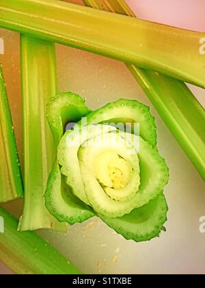 Celery stalks and heart on cutting board. Stock Photo
