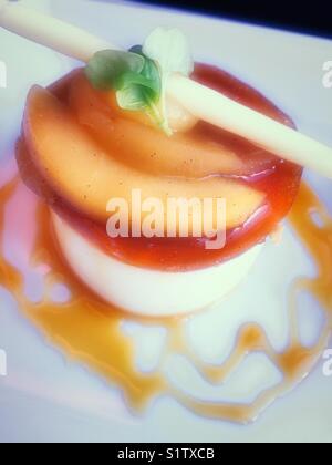 Flan dessert with white chocolate garnish, upscale gourmet restaurant USA Stock Photo