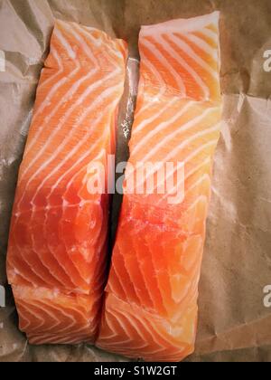 Two fresh salmon fillets on butcher paper close-up Stock Photo