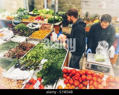 Vendors selling vegetables on a market stall at the Thursday market in Javea, Alicante Province, Spain Stock Photo